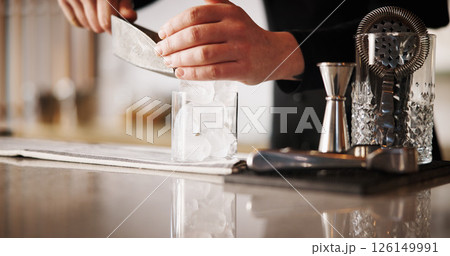 Cocktail, ice and hands of bartender man with glass, cafe and tools for artisan beverage recipe. Mixology, small business pub and barman at counter with happy hour drinks, process and craft alcohol 126149991
