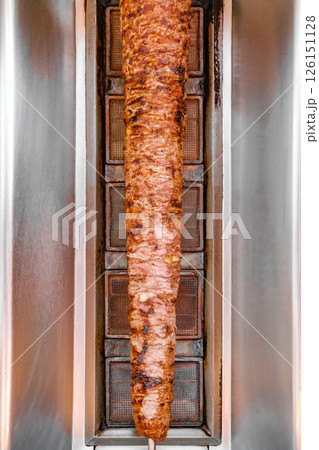 shawarma grills vertical skewered layers of succulent chicken typical meat served inside kebab sandwich 126151128