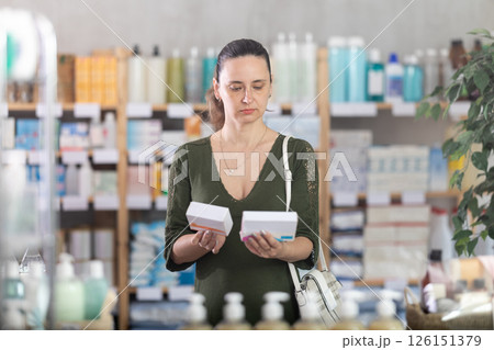Woman are busy choosing tablet box at pharmacy 126151379