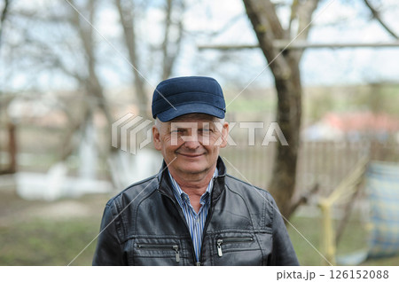 A gray-haired man on the street. Pensioner smiling on the street A gray-haired man on the street. Pensioner smiling on the street 126152088