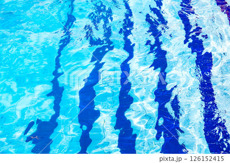 excitement on blue water in pool and blue stripes on the bottom 126152415