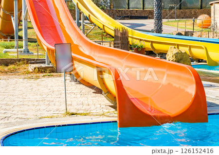 orange color waterslide at aquapark outdoor pool 126152416