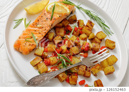 Oven-baked salmon fillet with fried potato, lemon Oven-baked salmon fillet with fried potato, lemon 126152463