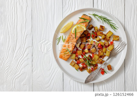 Oven-baked salmon fillet with fried potato, lemon Oven-baked salmon fillet with fried potato, lemon 126152466