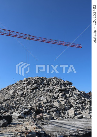 A crane is lifting a large pile of rocks 126152482