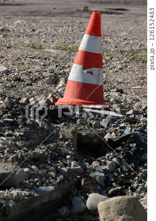 A cone is sitting in the dirt 126152483