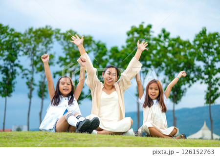 Happy mother and daughter spending time together in a park during spring. 126152763