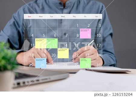 Businessman planning schedule with a digital calendar interface. Concept of time management, productivity, organization, task scheduling, and goal setting for business success and efficiency. Businessman planning schedule with a digital calendar interface. Concept of time management, productivity, organization, task scheduling, and goal setting for business success and efficiency. 126153204