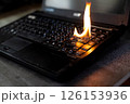 The computer laptop is burning with flames 126153936