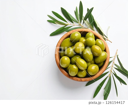 Wooden bowl of fresh green olives over white background 126154417