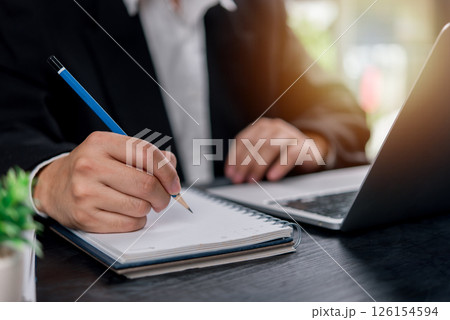 man hands with pen writing on notebook in the office.learning, education and work.writes goals, plans, make to do and wish list on desk. man hands with pen writing on notebook in the office.learning, education and work.writes goals, plans, make to do and wish list on desk. 126154594