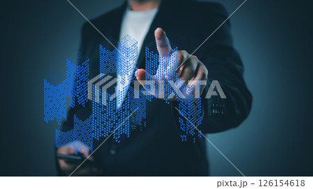 business professional analyzing digital representations of building growth and market trends using futuristic data visualization tools. 126154618