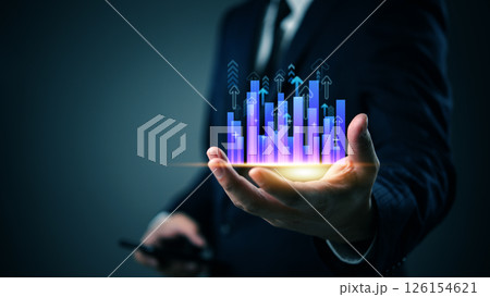 Businessman holding glowing bar chart with upward arrows, symbolizing business growth, financial success, data analytics, investment forecast and digital strategy. 126154621