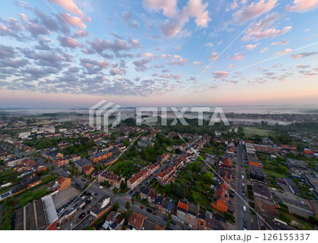 Aerial View Capturing the Serene Beauty of a Vibrant Sunrise Over a Charming Small Town 126155337