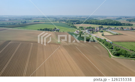 An EyeCatching Aerial View of Lush and Vibrant Farmland with Expansive Green Fields An EyeCatching Aerial View of Lush and Vibrant Farmland with Expansive Green Fields 126155338