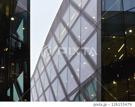 Rectangular windows on modern glass and steel building, overcast sky background, city life / modern architecture concept Rectangular windows on modern glass and steel building, overcast sky background, city life / modern architecture concept 126155479