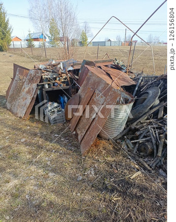 Haphazard Pile of Rusty Metal and Wood Scraps in Neglected Rural Style with Earthy Tones for Representing Waste or Recycling Haphazard Pile of Rusty Metal and Wood Scraps in Neglected Rural Style with Earthy Tones for Representing Waste or Recycling 126156804