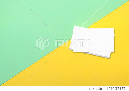 Top view of business business cards on colored background. Blank paper or sheet. Mockup or copy space for your design Top view of business business cards on colored background. Blank paper or sheet. Mockup or copy space for your design 126157171