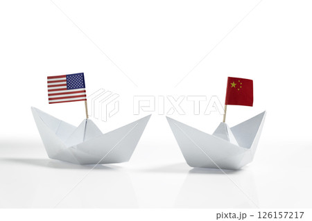 Paper boat with the USA or United States of America and China flags on a white background. Concept of the United States of America versus China trade war disputes or economic conflict 126157217