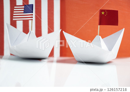 Paper boat with the USA or United States of America and China flags. Concept of the United States of America versus China trade war disputes or economic conflict 126157218