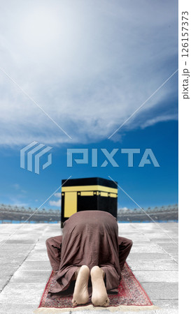 Rear view of an Indonesian southeast asian muslim man salat or praying in front of the Kaaba. Concept of hajj or umrah Rear view of an Indonesian southeast asian muslim man salat or praying in front of the Kaaba. Concept of hajj or umrah 126157373
