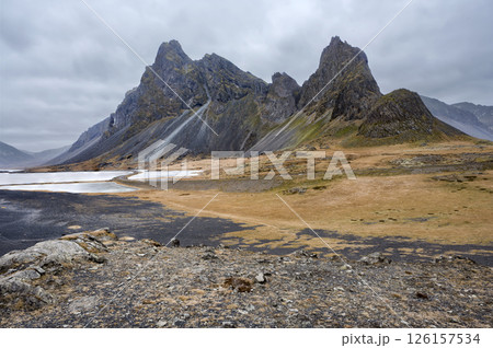 Panoramic view of mountain with black sand beach and coastline on Estrahorn, Iceland. Nature, travel, winter background, or wallpaper 126157534