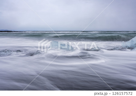 View of the melting glacier on the diamond beach on Jokulsarlon, Iceland. Nature, travel, climate change, global warming, winter background, or wallpaper View of the melting glacier on the diamond beach on Jokulsarlon, Iceland. Nature, travel, climate change, global warming, winter background, or wallpaper 126157572