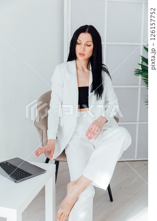 brunette in white suit with laptop job training online brunette in white suit with laptop job training online 126157752