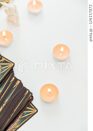Deck of tarot cards and candles on a background Deck of tarot cards and candles on a background 126157872