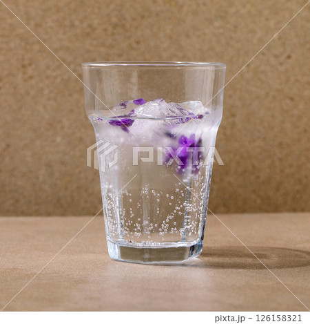 glass of soda with of violets flower 126158321
