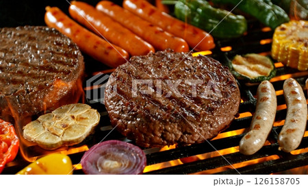 Close-up of Tasty Various Meat on Barbeque Grill with Roaring Flames 126158705
