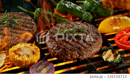 Close-up of Tasty Various Meat on Barbeque Grill with Roaring Flames 126158713