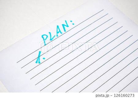 writing an action plan on white paper writing an action plan on white paper 126160273