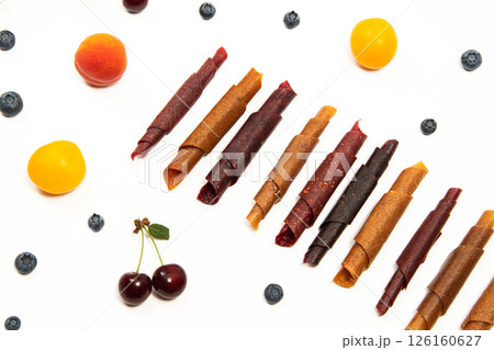 Pattern pastila fruit leather rolls up with fruits on white background. Horizontally.  126160627
