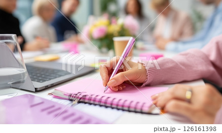 Team members engage in a collaborative meeting while taking notes and brainstorming ideas in a modern office space Team members engage in a collaborative meeting while taking notes and brainstorming ideas in a modern office space 126161398