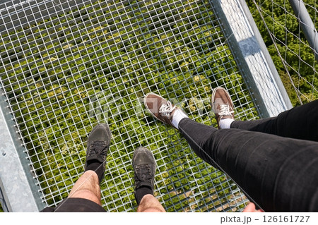 Standing on suspension walk bridge, looking down Standing on suspension walk bridge, looking down 126161727