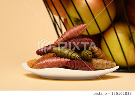 A white plate with pastilla. In the background is a basket of fruits. 126161838