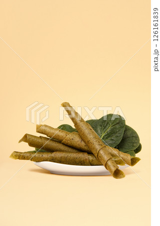 A plate of pastila with spinach on a beige background. Free space for text. 126161839