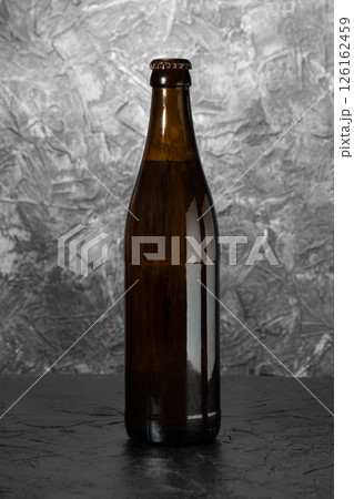 Bottle of beer on a dark gray background. 126162459