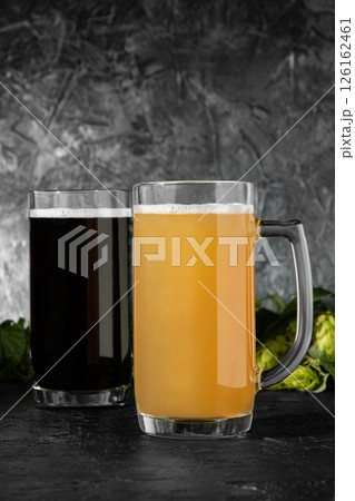 Two glasses of beer at Oktoberfest, light and dark. 126162461