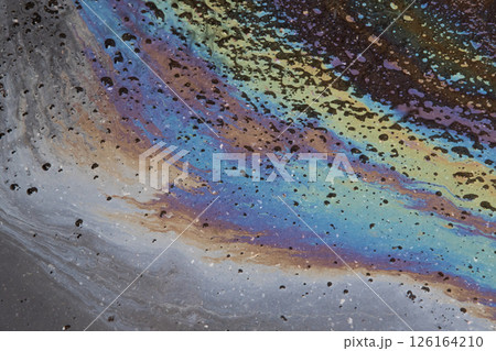 Oil slick on the asphalt road background. Stylish background image. 126164210