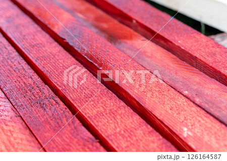 Red painted wooden planks creating a vibrant surface 126164587