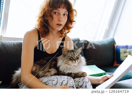 young woman spending time with her cat 126164719