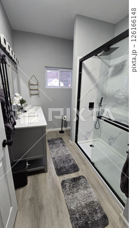 Modern Bathroom Interior Design, Clean and simple bathroom interior showcasing a functional bathtub, modern sink, and neatly arranged amenities for a refreshing and inviting atmosphere 126166148