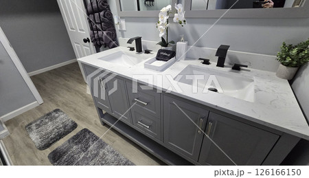 Modern Bathroom Interior Design, Clean and simple bathroom interior showcasing a functional bathtub, modern sink, and neatly arranged amenities for a refreshing and inviting atmosphere Modern Bathroom Interior Design, Clean and simple bathroom interior showcasing a functional bathtub, modern sink, and neatly arranged amenities for a refreshing and inviting atmosphere 126166150