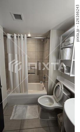 Modern Bathroom Interior Design, Clean and simple bathroom interior showcasing a functional bathtub, modern sink, and neatly arranged amenities for a refreshing and inviting atmosphere Modern Bathroom Interior Design, Clean and simple bathroom interior showcasing a functional bathtub, modern sink, and neatly arranged amenities for a refreshing and inviting atmosphere 126166243