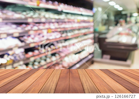Empty wood table top with supermarket blurred background for product display Empty wood table top with supermarket blurred background for product display 126166727