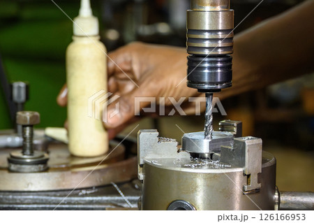 Close up scene the tapping process on CNC milling machine with tapping holder. 126166953