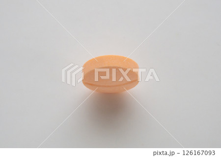 Orange medicine pill tablet on white background 126167093
