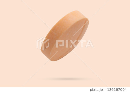 Orange medicine pill tablet flying on orange background 126167094